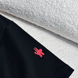 Flat lay presentation of Moncler luxury clothing with monogram-inspired silhouette
