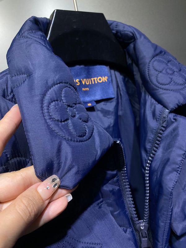 Flat lay presentation of Louis Vuitton luxury clothing with label-forward styling