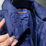 Flat lay presentation of Louis Vuitton luxury clothing with label-forward styling