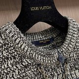 Close-up detail shot of Louis Vuitton luxury clothing with logo-detail design