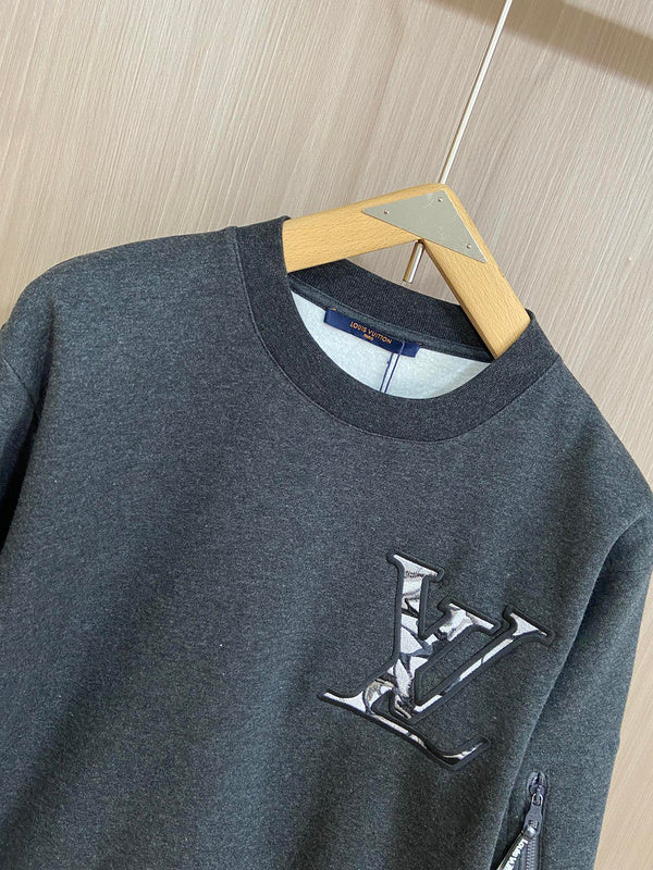 Close-up detail shot of Louis Vuitton luxury clothing with label-forward styling