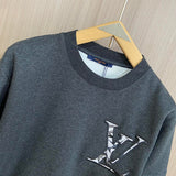 Close-up detail shot of Louis Vuitton luxury clothing with label-forward styling