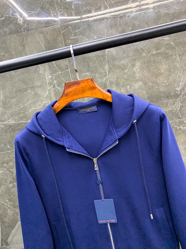 Flat lay presentation of Louis Vuitton luxury clothing with monogram-inspired silhouette