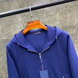 Flat lay presentation of Louis Vuitton luxury clothing with monogram-inspired silhouette