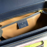 Side profile of signature polished women's handbag – women's luxury accessory