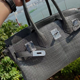 Side view of polished structured handbag