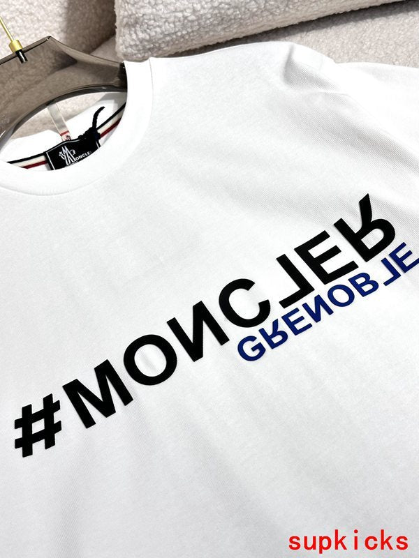 Flat lay presentation of Moncler luxury clothing with signature branding