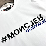 Flat lay presentation of Moncler luxury clothing with signature branding