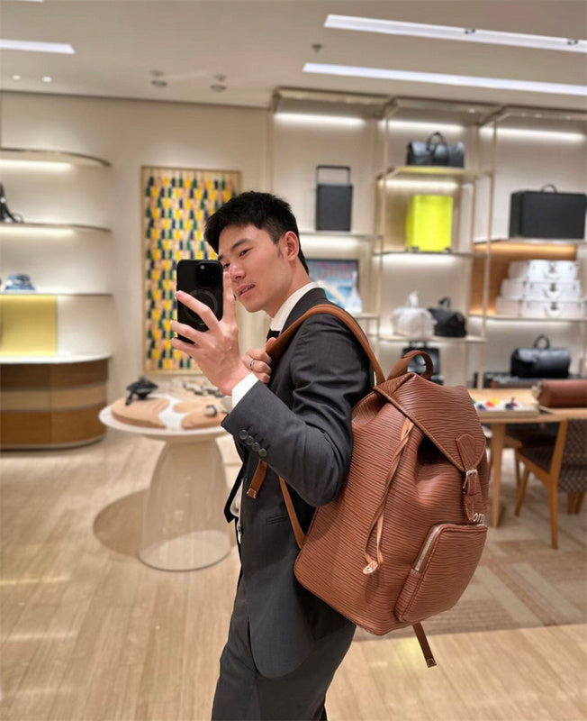 Signature top-handle bag carried on shoulder