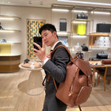  Signature top-handle bag carried on shoulder