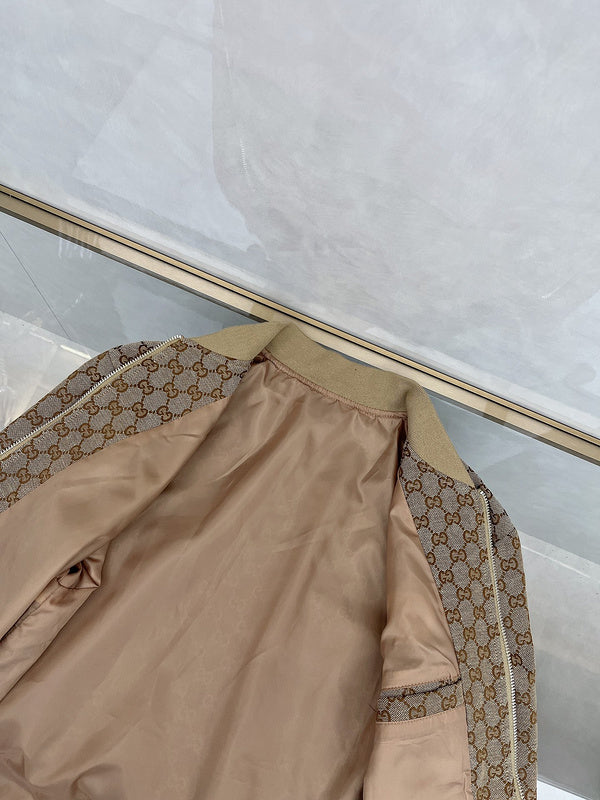 Flat lay presentation of Gucci luxury clothing with monogram-inspired silhouette