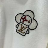 Flat lay presentation of Louis Vuitton luxury clothing with logo-detail design