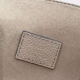 Side profile of structured polished women's handbag – women's luxury accessory