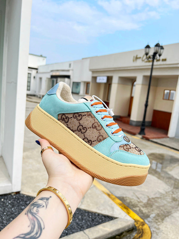 Side profile of Gucci classic monochrome sneakers retro runner design