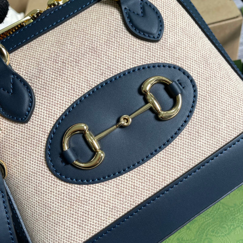 Handle and strap detail of polished structured women's handbag – women's designer-style accessory