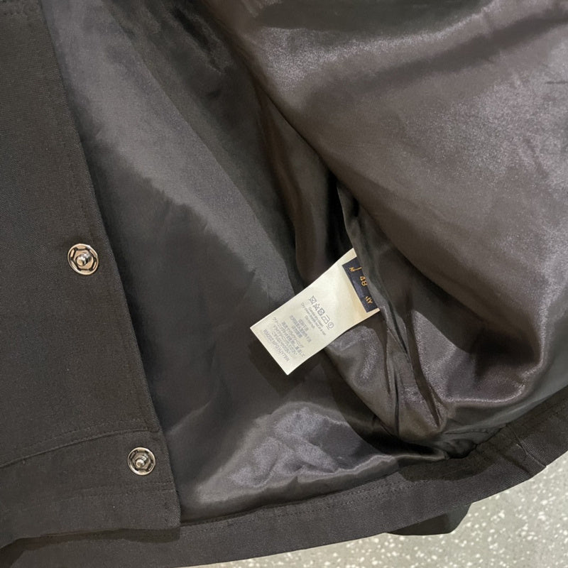 Close-up detail shot of Louis Vuitton luxury clothing with runway-inspired design