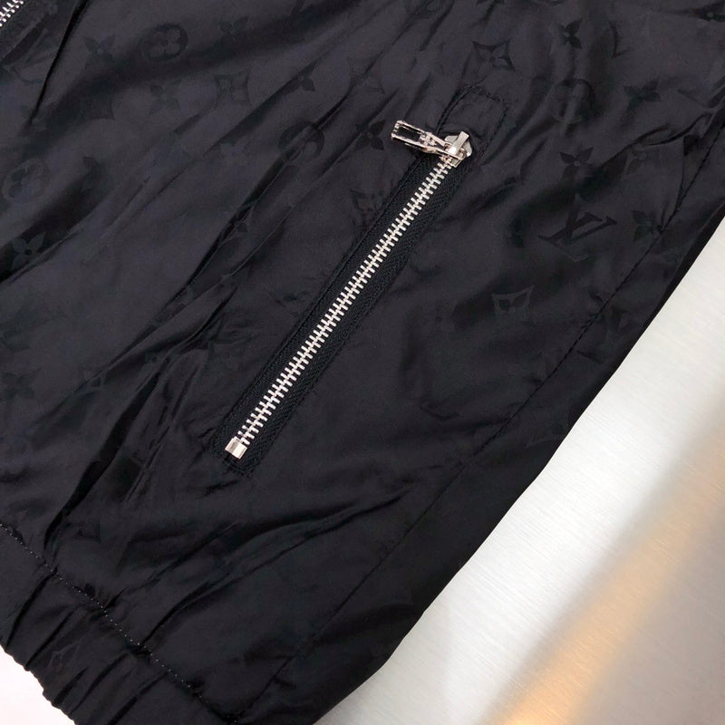 Flat lay presentation of Louis Vuitton luxury clothing with signature branding