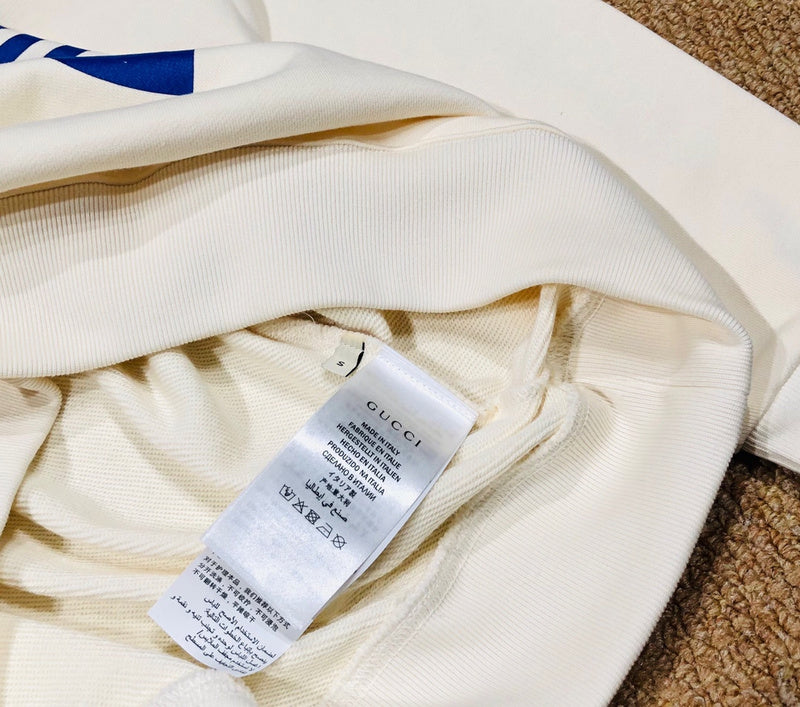 Close-up detail shot of Gucci luxury clothing with monogram-inspired silhouette