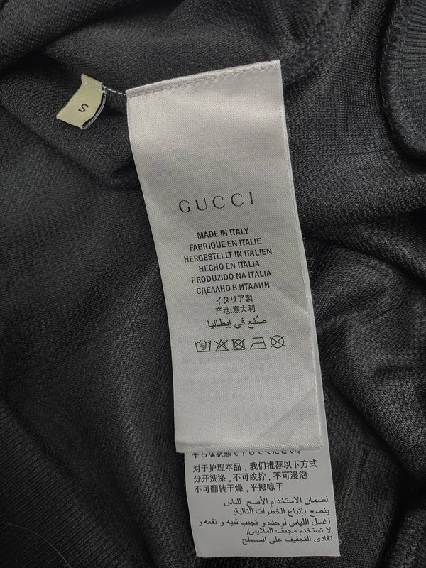 Back view of Gucci luxury clothing with label-forward styling