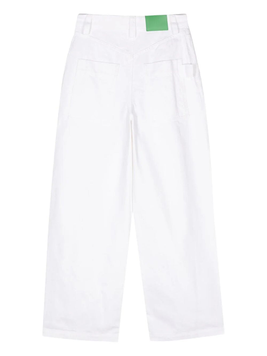 Close-up of Bottega Veneta pants hardware and fine stitching