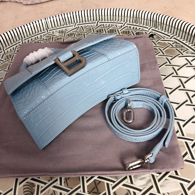 Handle and strap detail of structured polished women's handbag – women's designer-style accessory