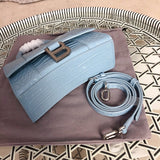Handle and strap detail of structured polished women's handbag – women's designer-style accessory