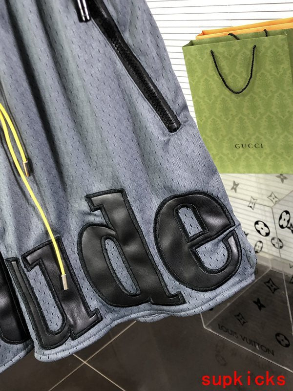 Flat lay presentation of Rhude luxury clothing with monogram-inspired silhouette