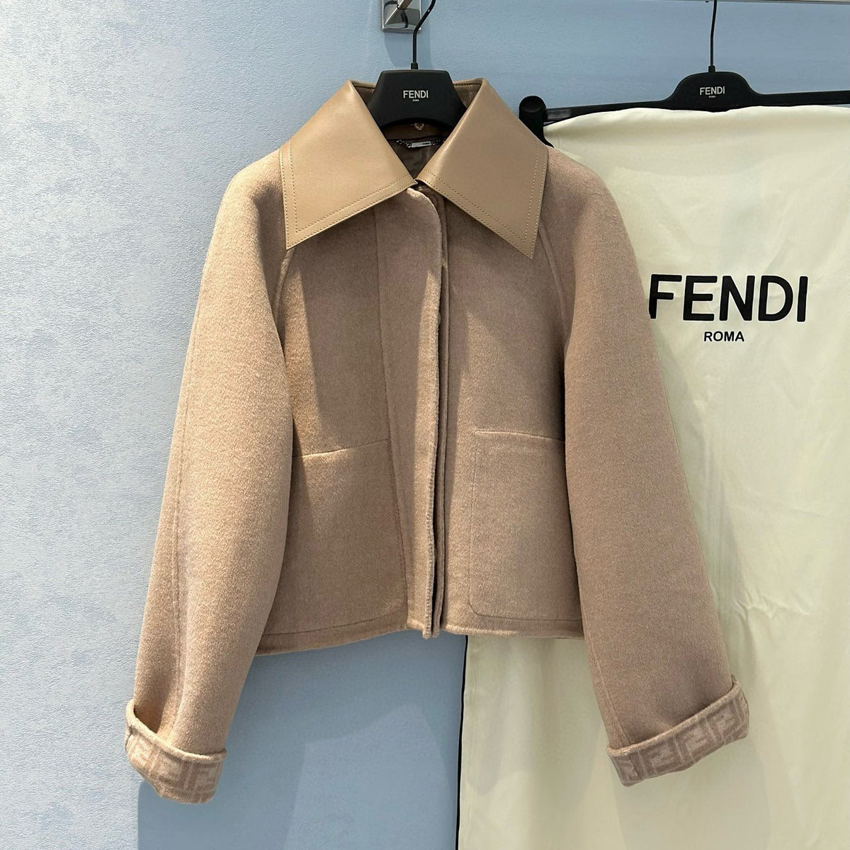 Front view of Fendi premium Coat with iconic logo hardware