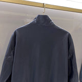 Close-up detail shot of Louis Vuitton luxury clothing with signature branding
