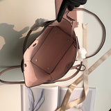 Side profile of elevated signature women's handbag – women's statement bag