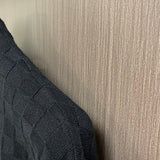 Back view of Louis Vuitton luxury clothing with label-forward styling