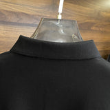 Flat lay presentation of Louis Vuitton luxury clothing with label-forward styling
