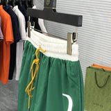 Flat lay presentation of Rhude luxury clothing with label-forward styling