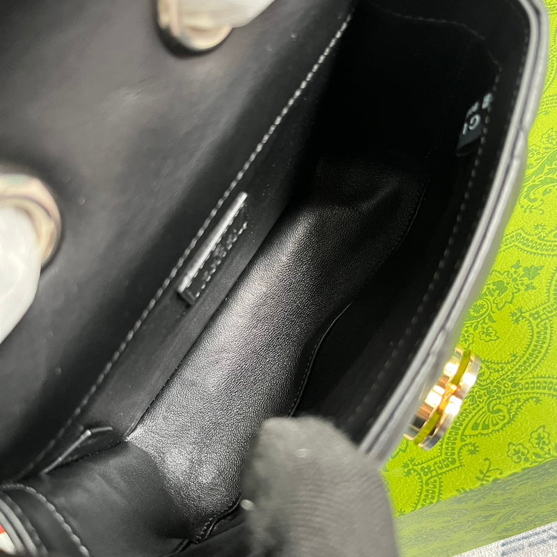 Close-up detail of signature polished women's handbag – women's luxury accessory