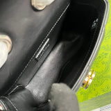 Close-up detail of signature polished women's handbag – women's luxury accessory