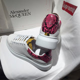 Side profile of Alexander McQueen fresh white-and-black sneakers signature lace-up style