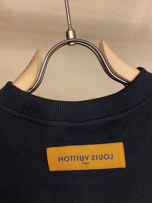 Close-up detail shot of Louis Vuitton cotton t-shirt with signature branding