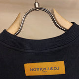 Close-up detail shot of Louis Vuitton cotton t-shirt with signature branding