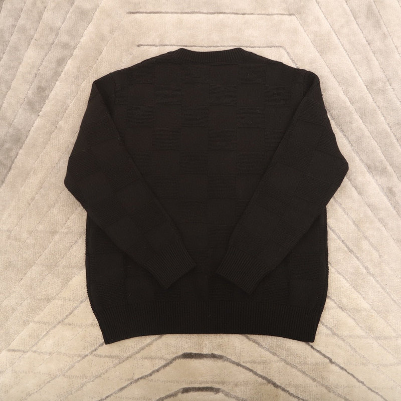Close-up detail shot of Louis Vuitton luxury clothing with logo-detail design