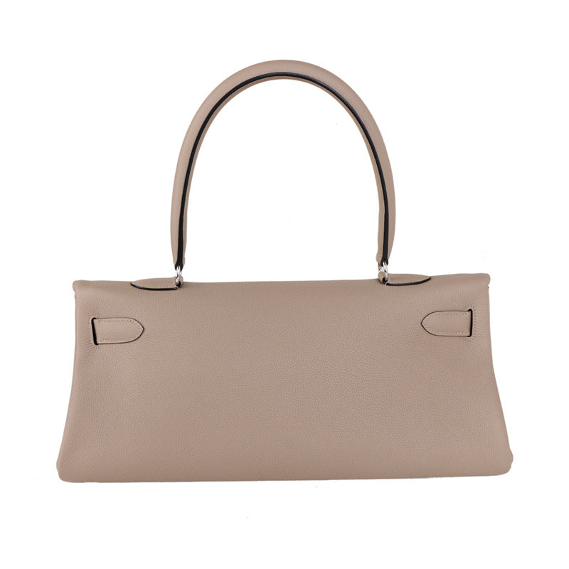  Signature top-handle bag carried on shoulder