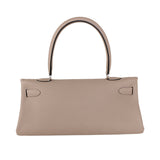  Signature top-handle bag carried on shoulder