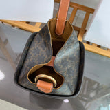Side profile of elevated signature women's handbag – women's luxury accessory