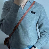 Close-up detail shot of Lacoste luxury clothing with monogram-inspired silhouette