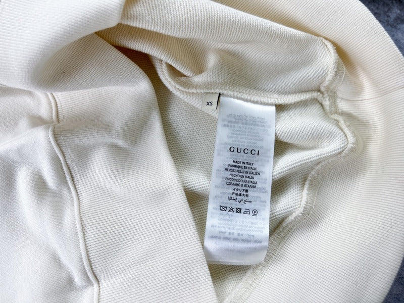 Front view of Gucci luxury clothing with signature branding