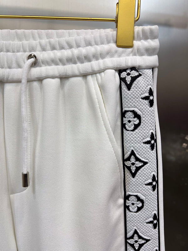 Flat lay presentation of Louis Vuitton luxury clothing with runway-inspired design