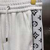 Flat lay presentation of Louis Vuitton luxury clothing with runway-inspired design