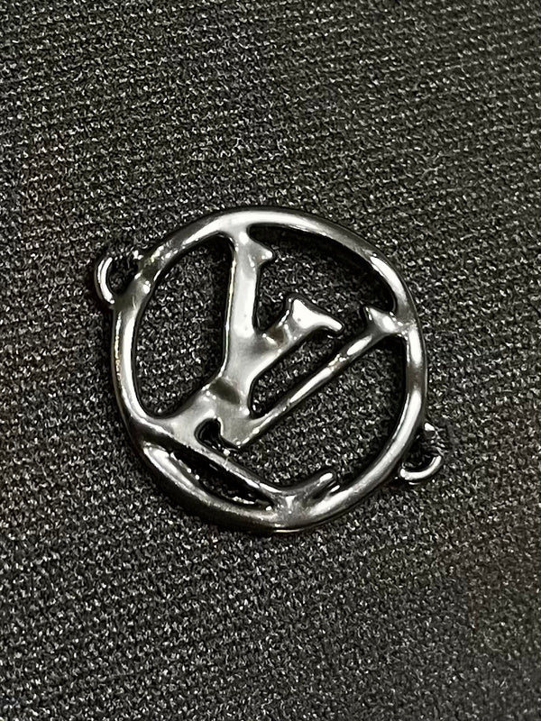 Close-up detail shot of Louis Vuitton luxury clothing with signature branding