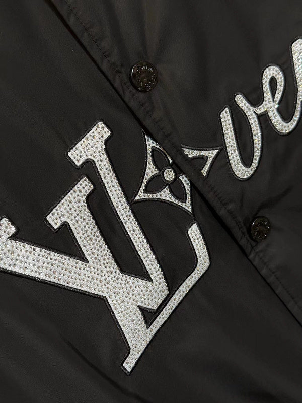 Flat lay presentation of Louis Vuitton luxury clothing with label-forward styling