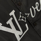Flat lay presentation of Louis Vuitton luxury clothing with label-forward styling