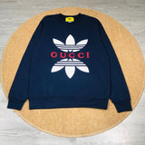 Close-up detail shot of Gucci luxury clothing with monogram-inspired silhouette